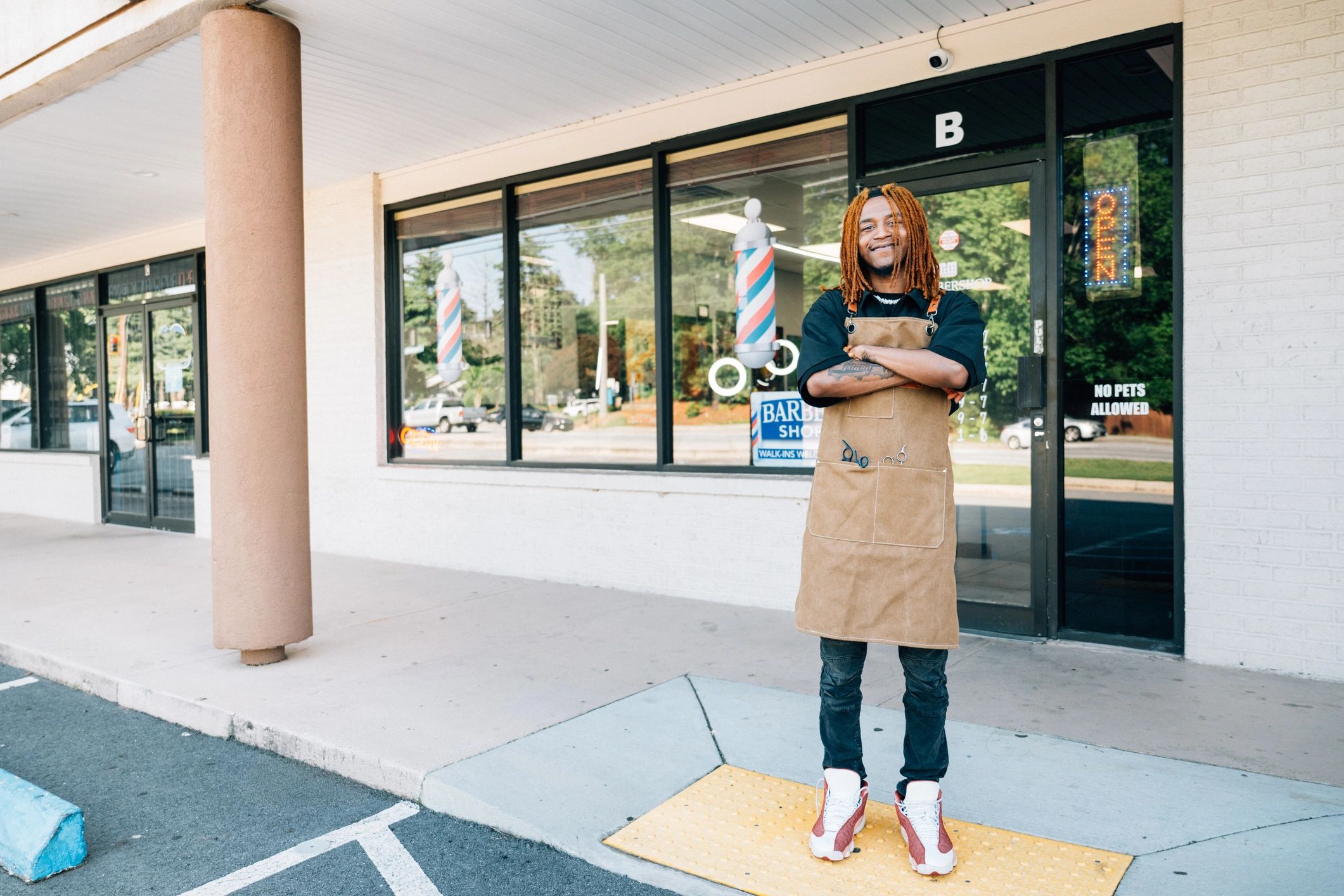 Local small business owner standing outside a storefront
